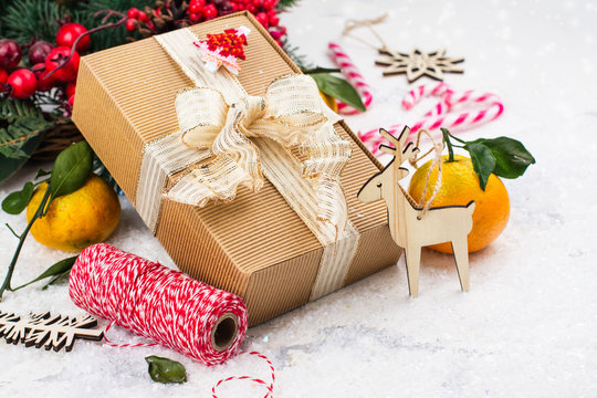Christmas present with golden sparkles ribbon on white Christmas decorated background. Winter holidays concept. Copy space