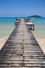 Fototapeta na wymiar Wooden jetty on exotic beach Koh Chang island, Thailand