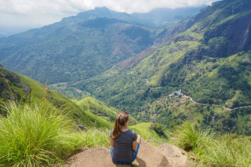 Naklejka na ściany i meble Female Tourist at Ella Peak Mountain in Sri Lanka