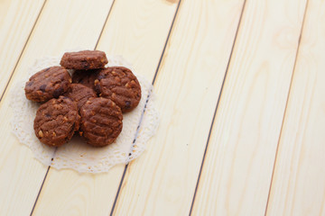 Chocolate chip cookies on wooden background.