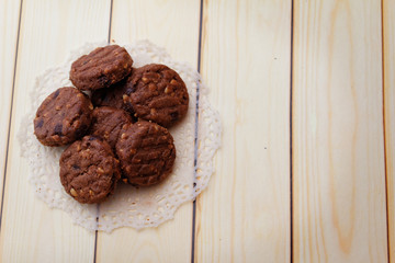 Chocolate chip cookies on wooden background.