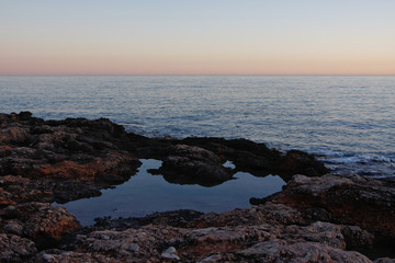 stoney ocean beach sunset in spain