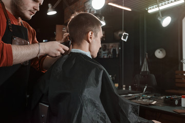 clipper/ Barber cutting in barbershop. Hair clipper