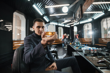 glass of whiskey and logo/ The client is a hairdresser with a glass of whiskey. Place for logo