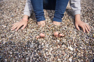 His feet buried in coastal shingle 8641.