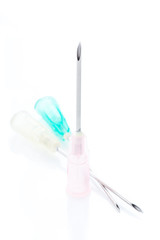 close up of three size disposable hypodermic needles  on white background