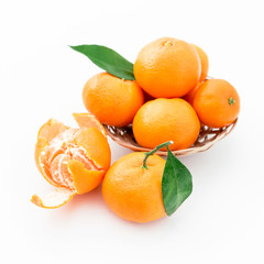 Mandarin with leaf in plate on white background. Citrus fruits. Top view.