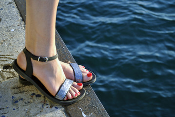 woman's legs against the sea