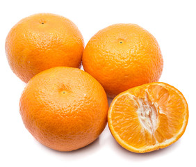 Three whole Clementines and one half isolated on white background