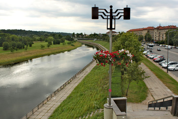 View from a city bridge on Neman river in Kaunas along the street with old buildings