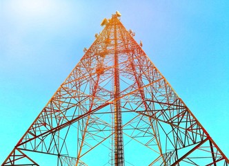 Telecommunication tower in beautiful clear sky. Artificial light was added on the top left corner.
