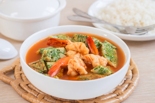 Acacia leave omelet and shrimp in sour soup and rice on plate,  Thai food