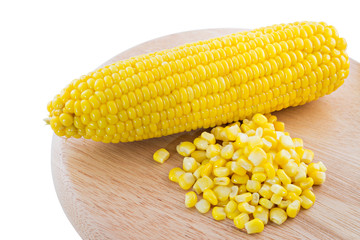 ear of corn and canned corn on Wood tray isolated on white background, selective focus (detailed close-up shot)