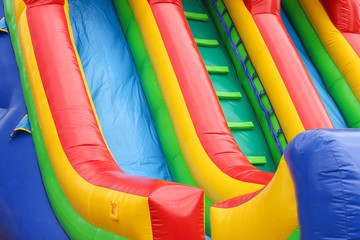 Fototapeta na wymiar a colourful inflatable slide at a carnival