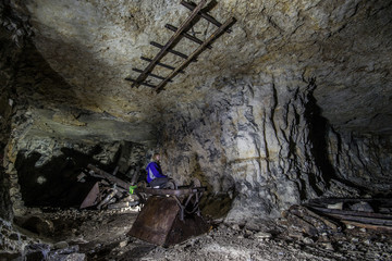 Miner at old wooden timbering in an abandoned limestone mine in Sock, Samara Region