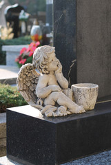 : statue of a little angel on the cemetery in Sviadnov, Czech Republic