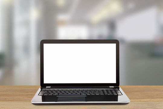 Laptop with blank white screen on blurred modern office background, business concept