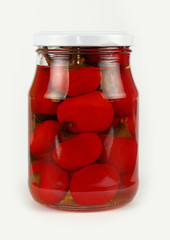 Jar of pickled red hot chili peppers over white
