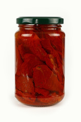 Jar of pickled sundried tomatoes over white