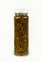 Jar of pickled green peppercorns over white