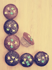 chocolate muffins on wooden ground