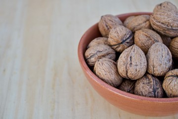 Walnuts on  earthenware container - right
