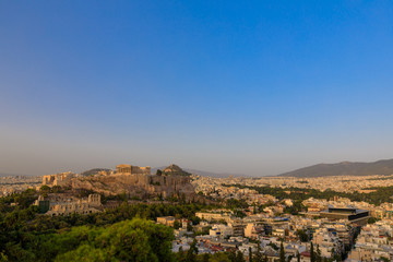 Obraz premium View to Parthenon, Akropolis from Filopappou Hill or Hill of the Muses at sunset on sunny summer day