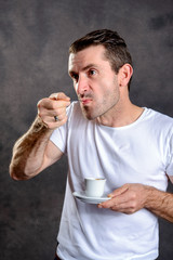 Fototapeta premium dark haired man drinking espresso