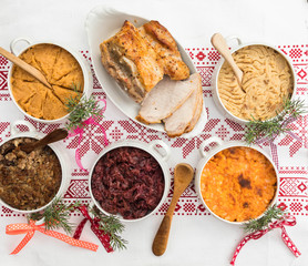 Finnish traditional Christmas table.potato, carrot, chestnut, red cabbage and liver casserole, ham and the vinaigrette Top view. Rustic style