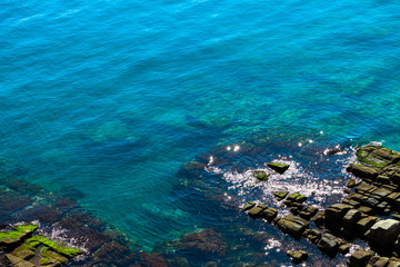 Fototapeta na wymiar Mediterranean sea, Greece, clean blue water lagoon. Beautiful sea shore, rocks, natural backdrop.