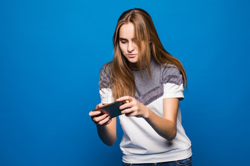 Woman play game on phone on blue background