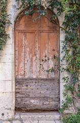 Old wooden door in the entrance stone French house