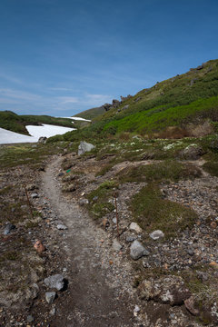 Rocky hiking trail over the mountain ranges of Daisetsuzan National Park, Hokkaido, Japan