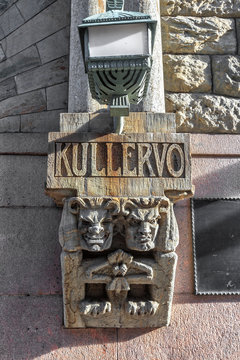 Two stone trolls embedded in a Helsinki building.