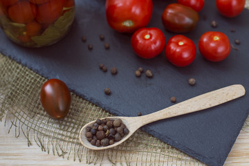 Pepper peas in wooden spoon and fresh tomatoes