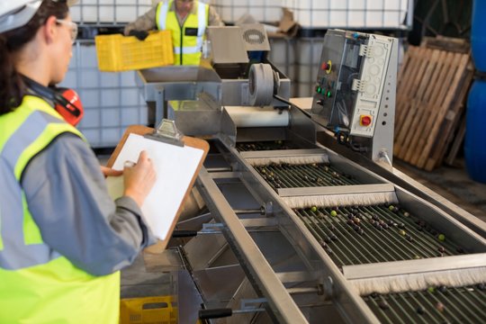 Female technician writing on clipboard