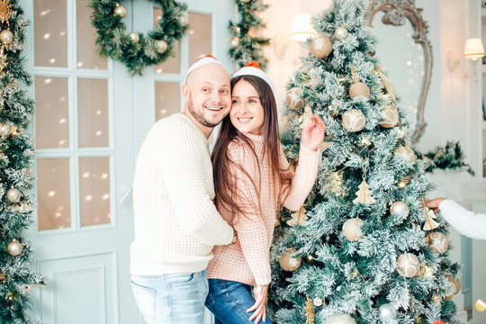 Cute, Young Couple Decorating A Christmas Tree