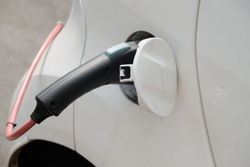Electric car being recharged at charging station