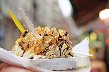 The Belgian wafer. Delicious Belgian waffle with cream, fruit and sauce looks beautiful in the window of the Brussels confectionery store.