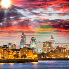 Canary Wharf night skyline with Thames river reflections, London - UK