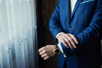 Obraz na płótnie Canvas Businessman wears a jacket.Politician, man's style,male hands closeup, American, European businessman, business, fashion and clothing concept