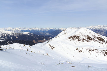 Mountain panorama with snow, trees and blue sky in winter in Stubai Alps, Austria