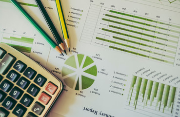 Obraz premium Pen on diagram chart and graphs business report with money, compass, calculator on desk of financial advisor. Accounting and Financial Planning Concept. top view.