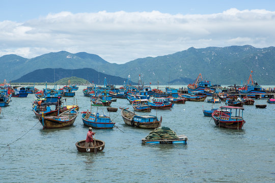 Traditional old wooden Vietnamese boats and round fishing boats Thung Chai. Local woven bamboo basket boats or coracle moored near harbour. Vietnam
