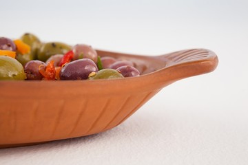 Cropped image of olives served in wooden container