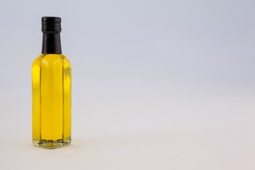 Yellow oil bottle against wall