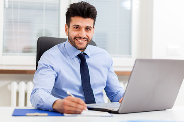 Young manager working in his office