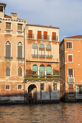 Grand Canal, vintage buildings, parked boats at the marina, Venice, Italy