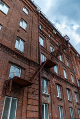 Obraz premium Metal ladder on old brick facade