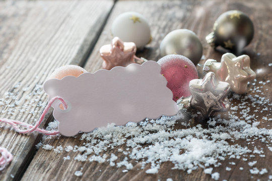 White and pink christmas decoration with a little card